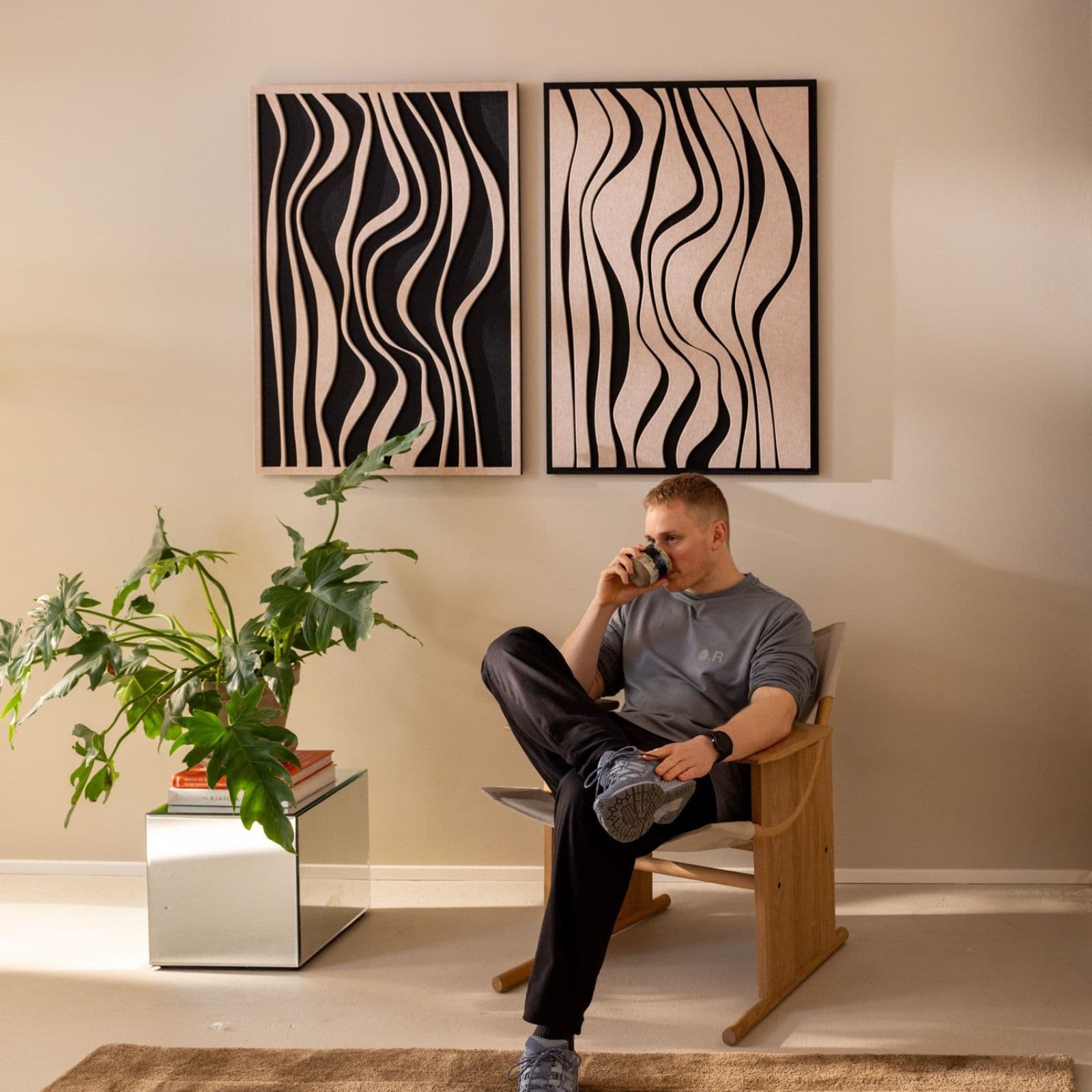 Decorative soundproofing panels mounted above a cozy reading corner, adding acoustic balance and visual rhythm to the space.