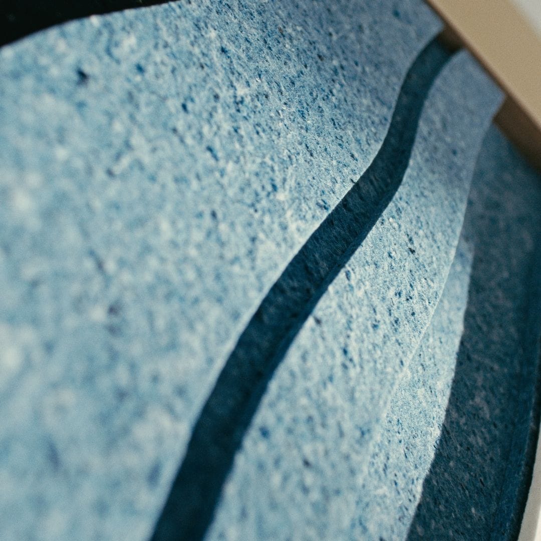 Close-up of new modern art panel in blue, featuring layered textures made from sustainable materials.